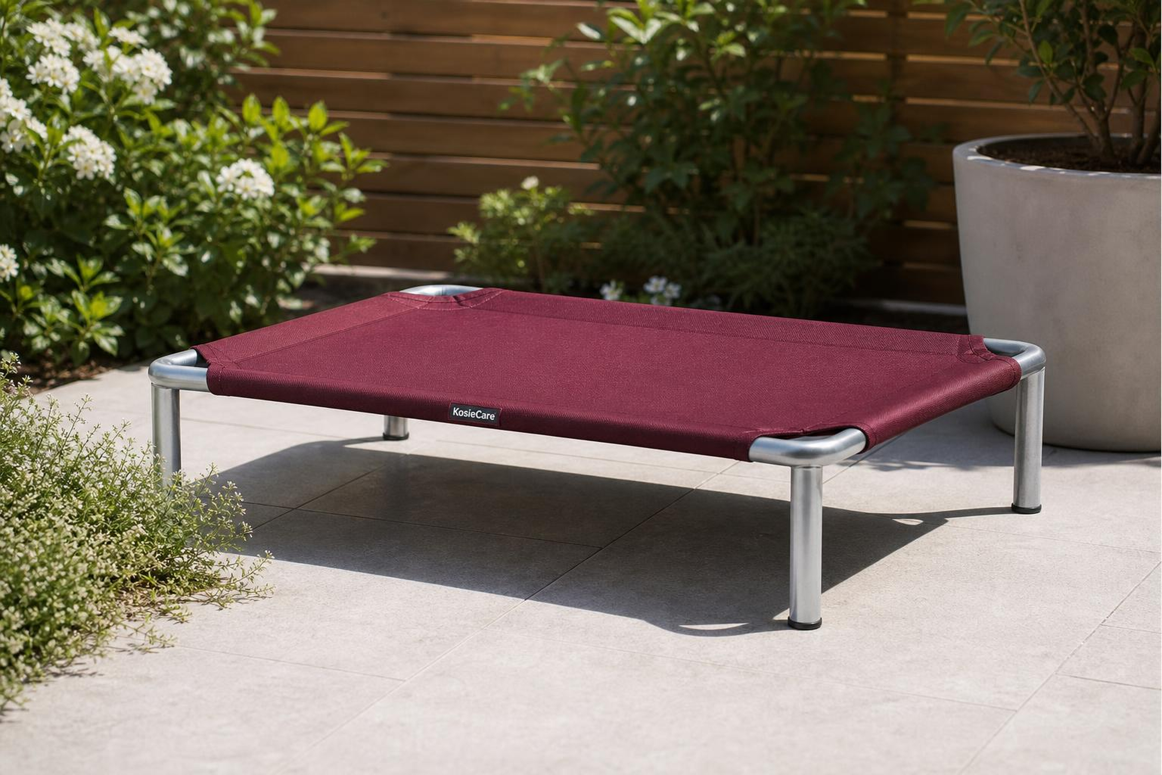 Handmade terracotta KosieCare dog bed outdoors in a Co. Wexford garden alongside the Lavender & Oilsorts range