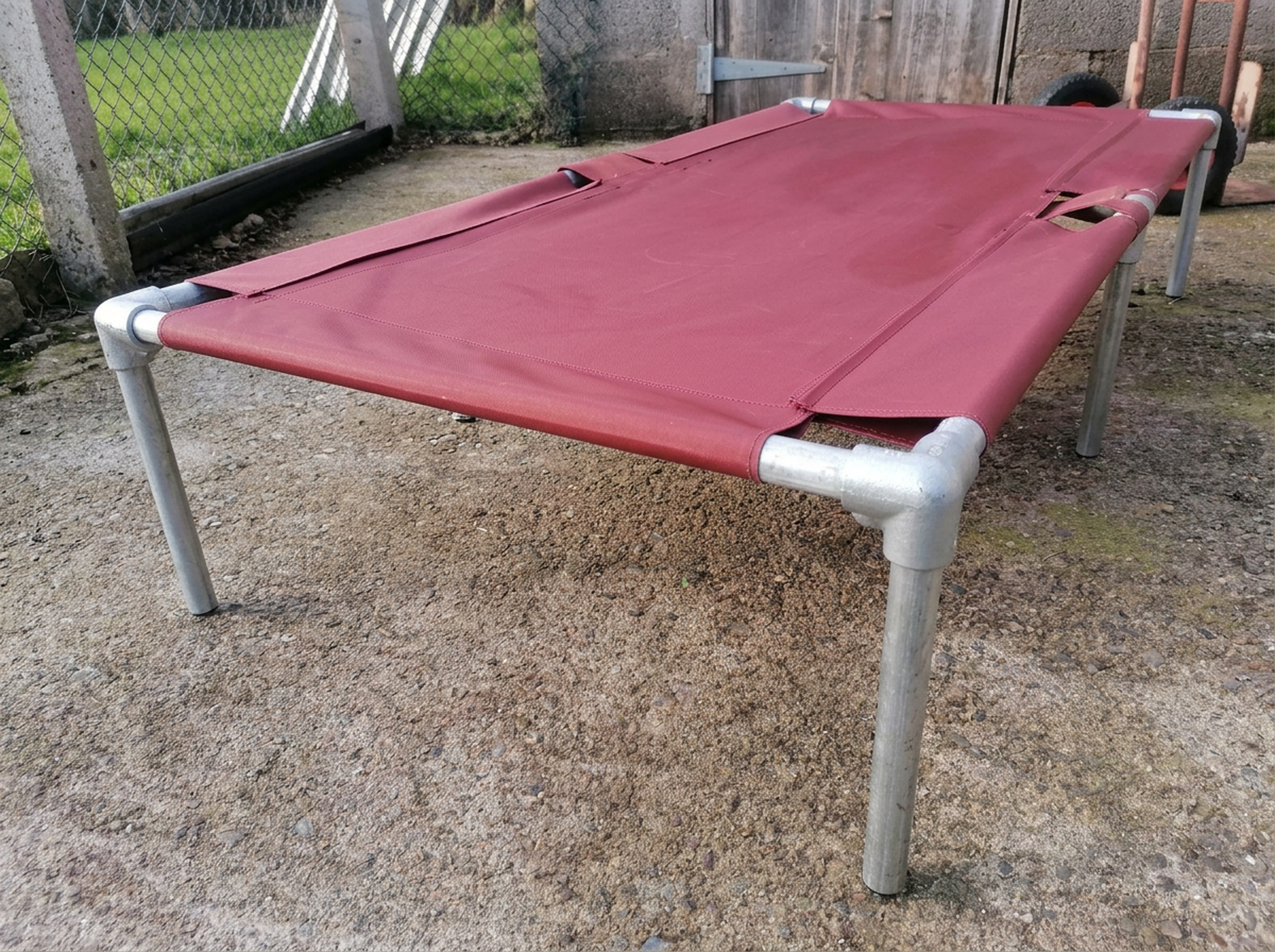Large KosieCare bed on gravel outdoors